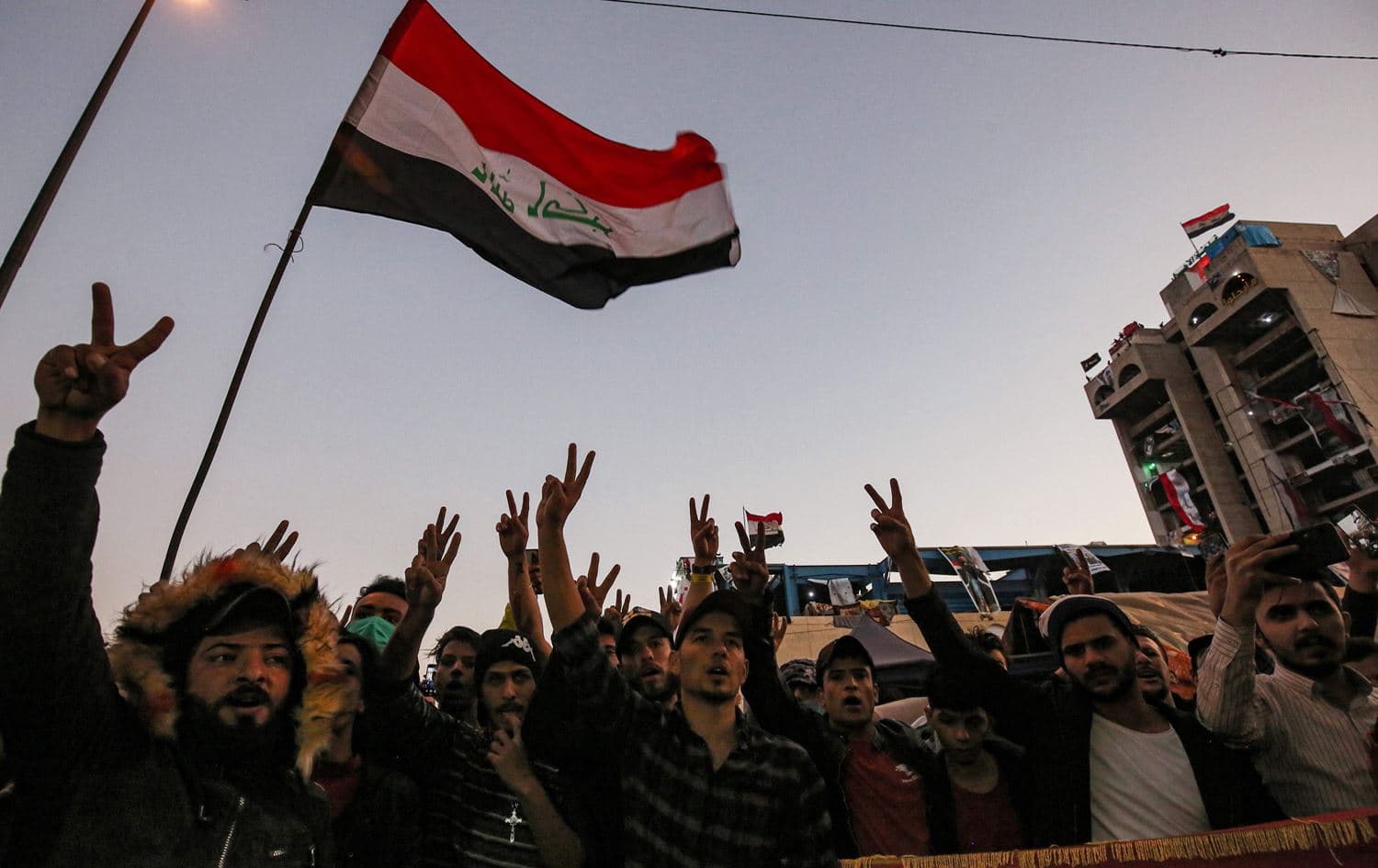 Iraqi anti-government protesters celebrate in Baghdad's Tahrir Square on December 24, 2019, after parliament approved a new electoral law. Photo: Ahmad al-Rubaye/AFP