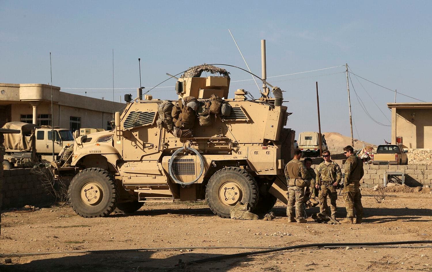 US Army soldiers stand outside their armored vehicle on a joint base with Iraqi army south of Mosul, Iraq on February 23 2017.Photo: Khalid Mohammed/AP