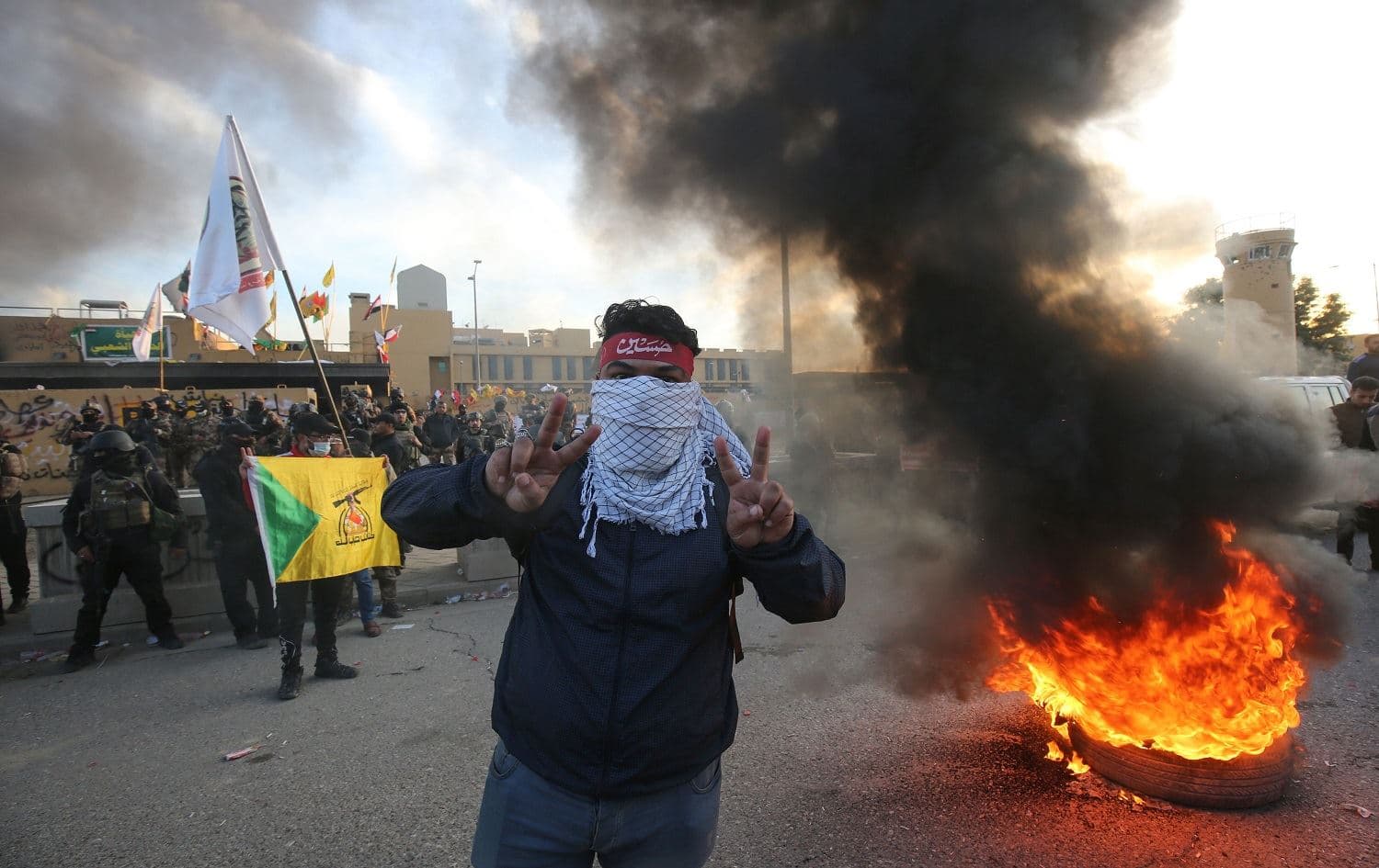 A supporter of Iraq's Hashd al-Shaabi paramilitary force flashes victory signs during a protest outside the US embassy in Baghdad on January 1, 2020. Photo: Ahmed al-Rubaye/AFP