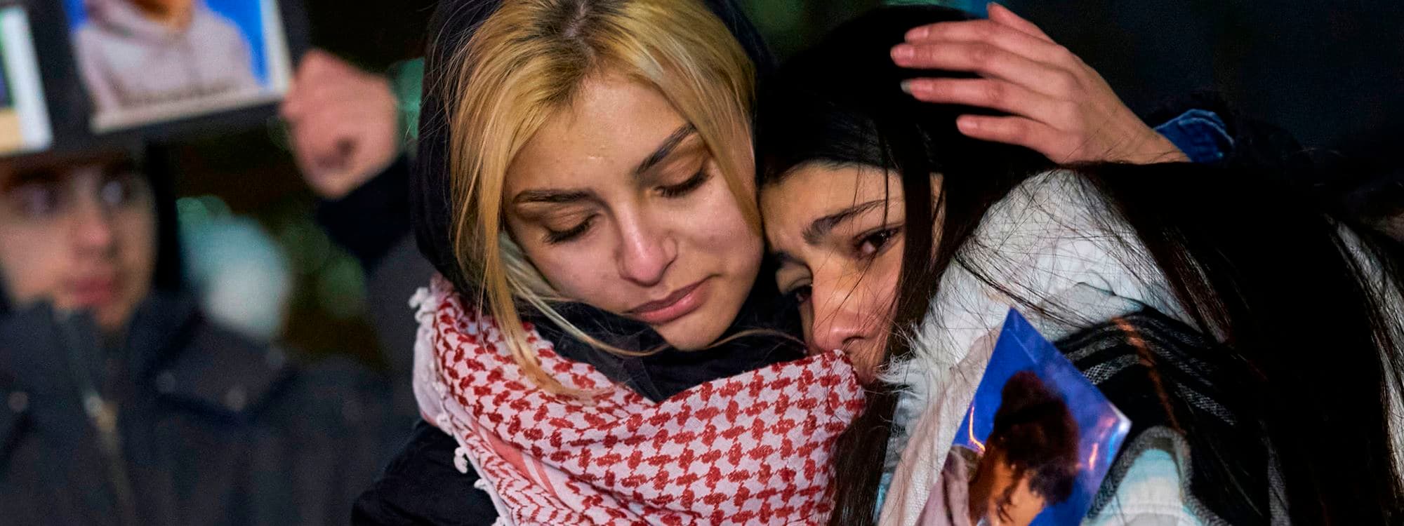 Mourners console each other during a vigil for the victims of Ukrainian Airlines flight 752 which crashed in Iran during a vigil at Mel Lastman Square in Toronto, Ontario on January 9, 2020. Photo: Geoff Robins/AFP