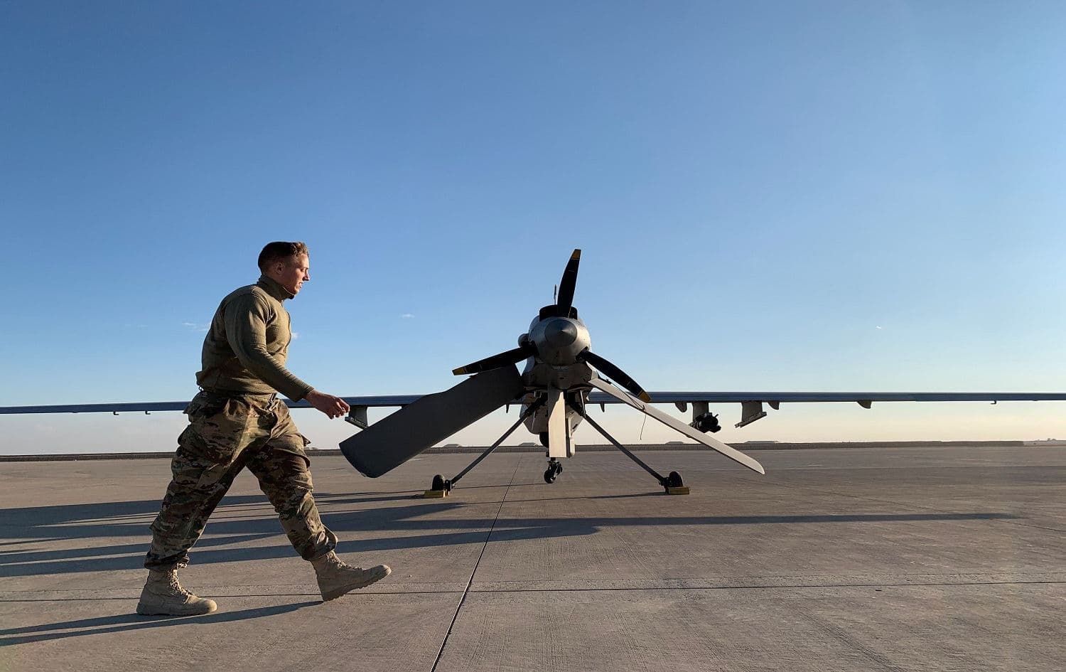 A US soldier walks past a drone at the Ain al-Asad airbase in Anbar province on January 13, 2020 Photo: Ayman Hanna/AFP.