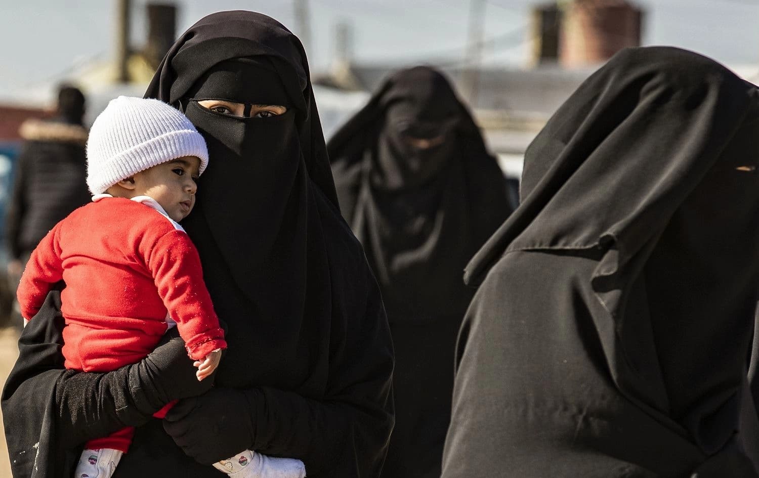 A woman carrying a baby inside the Kurdish-run Al-Hol camp in Hasaka, Syria, January 25, 2020. Photo: Delil Souleiman / AFP 