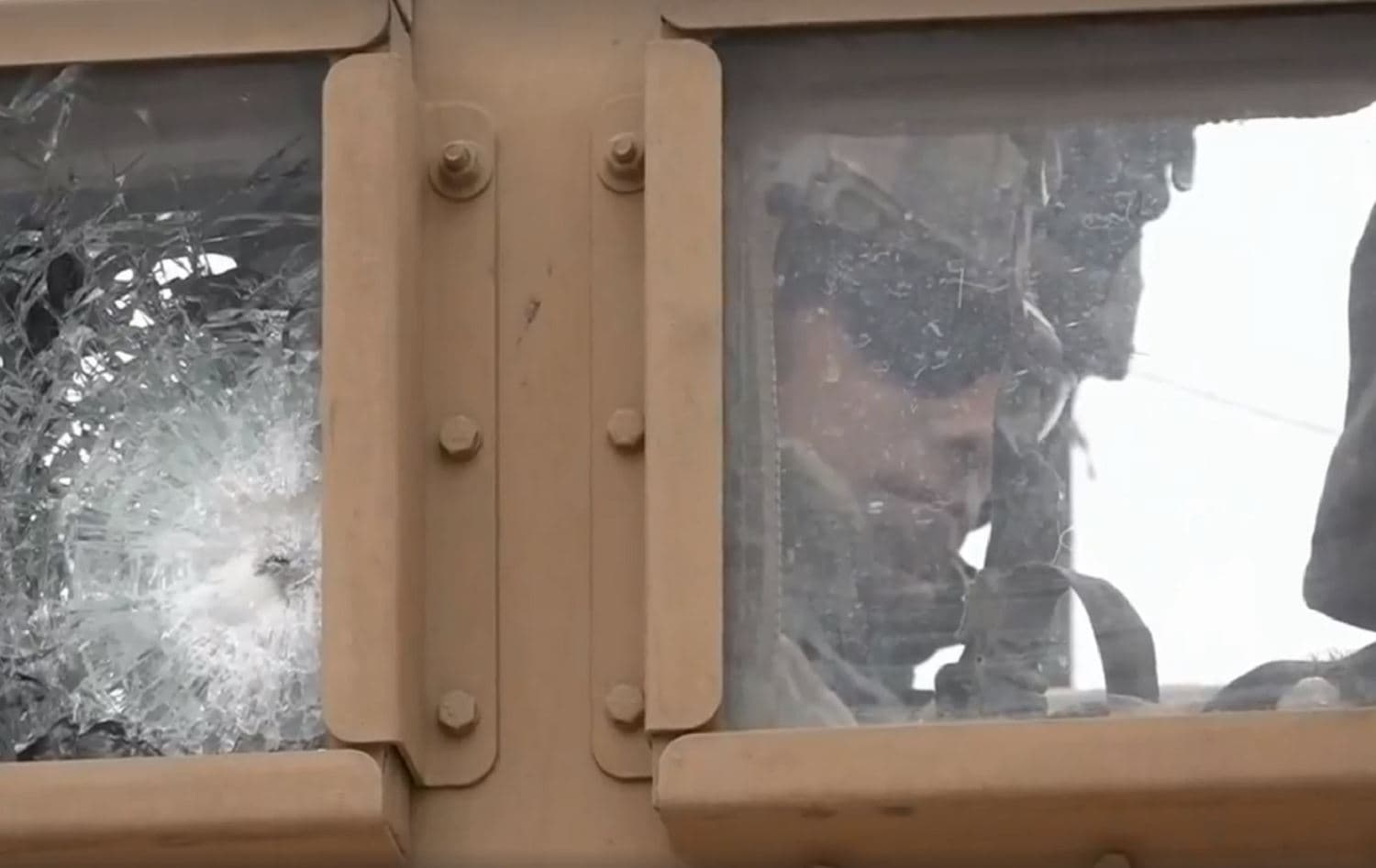 An American armored vehicle with glass shattered by bullets sits in the vicinity of the village of Khirbet Amo on February 12, 2020. Screenshot taken from Rudaw footage