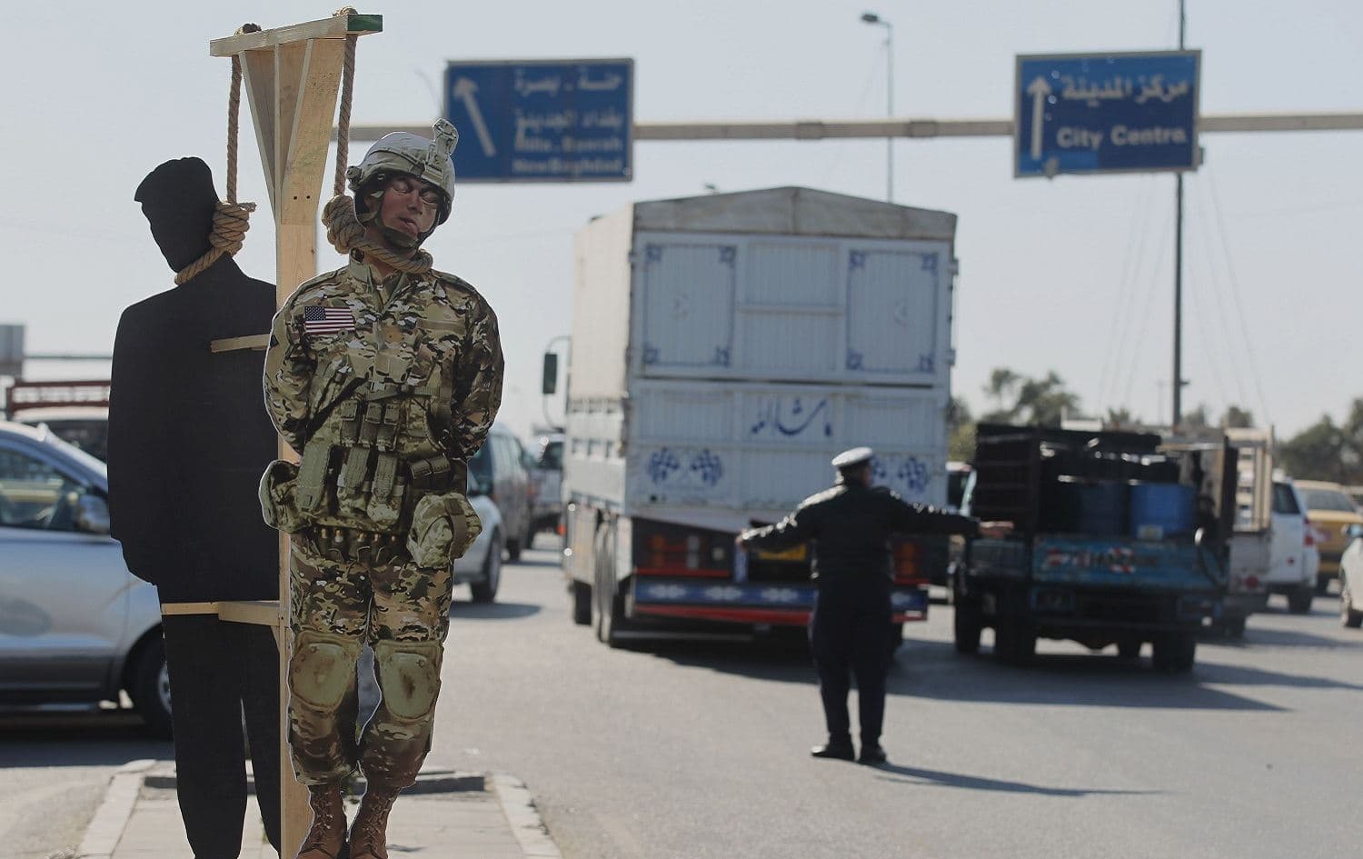A wooden cutout depicting a US army soldier and US President Donald Trump (behind) hang from a symbolic gallows along a street in the Iraqi capital Baghdad's eastern Sadr City suburb, February 10, 2020. Photo: Ahmad al-Rubaye / AFP