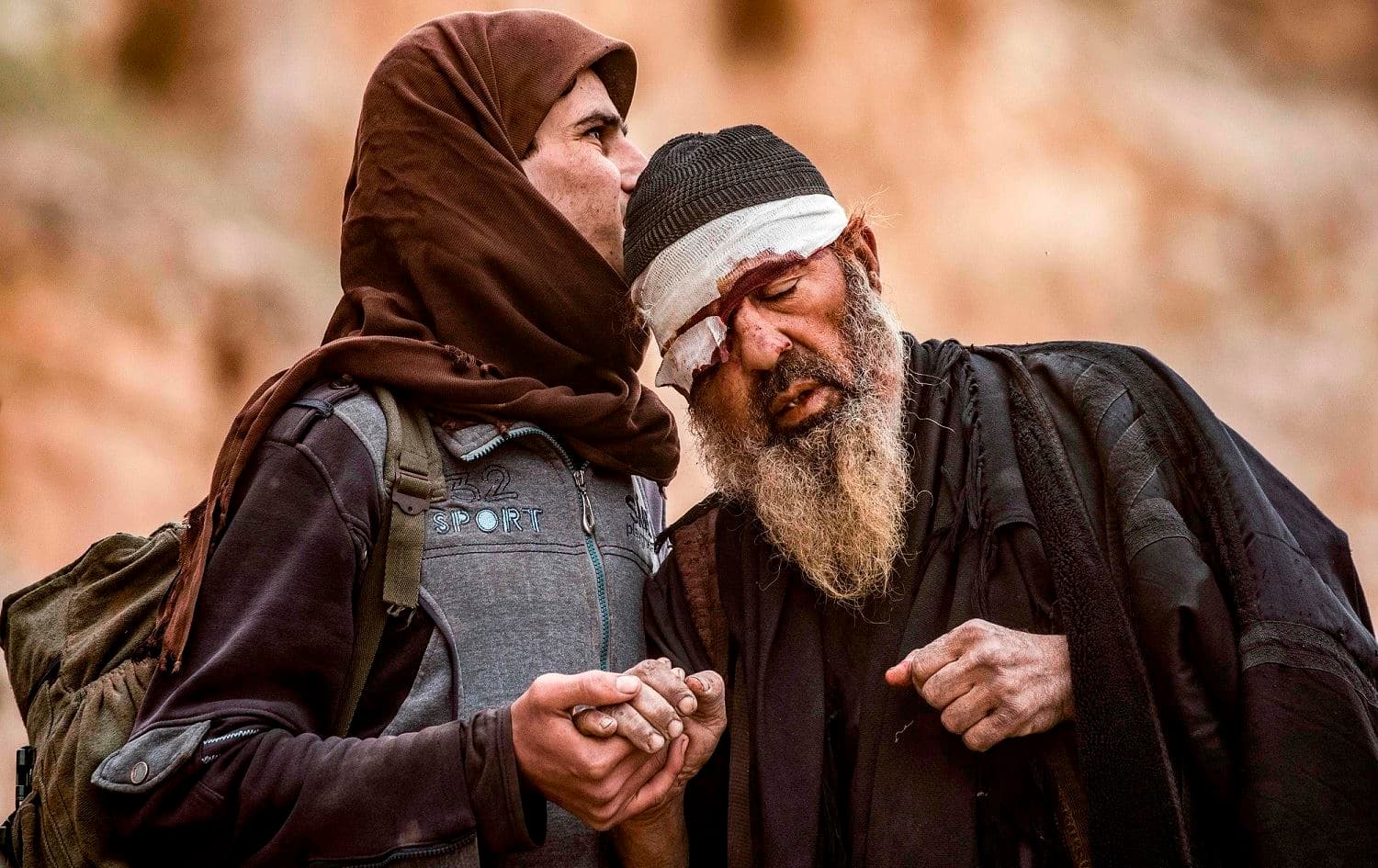 Two men leave the village of Baghouz in the eastern Syrian province of Deir ez-Zor following its liberation from ISIS by the SDF, March 14, 2019. File photo: Delil Souleiman / AFP