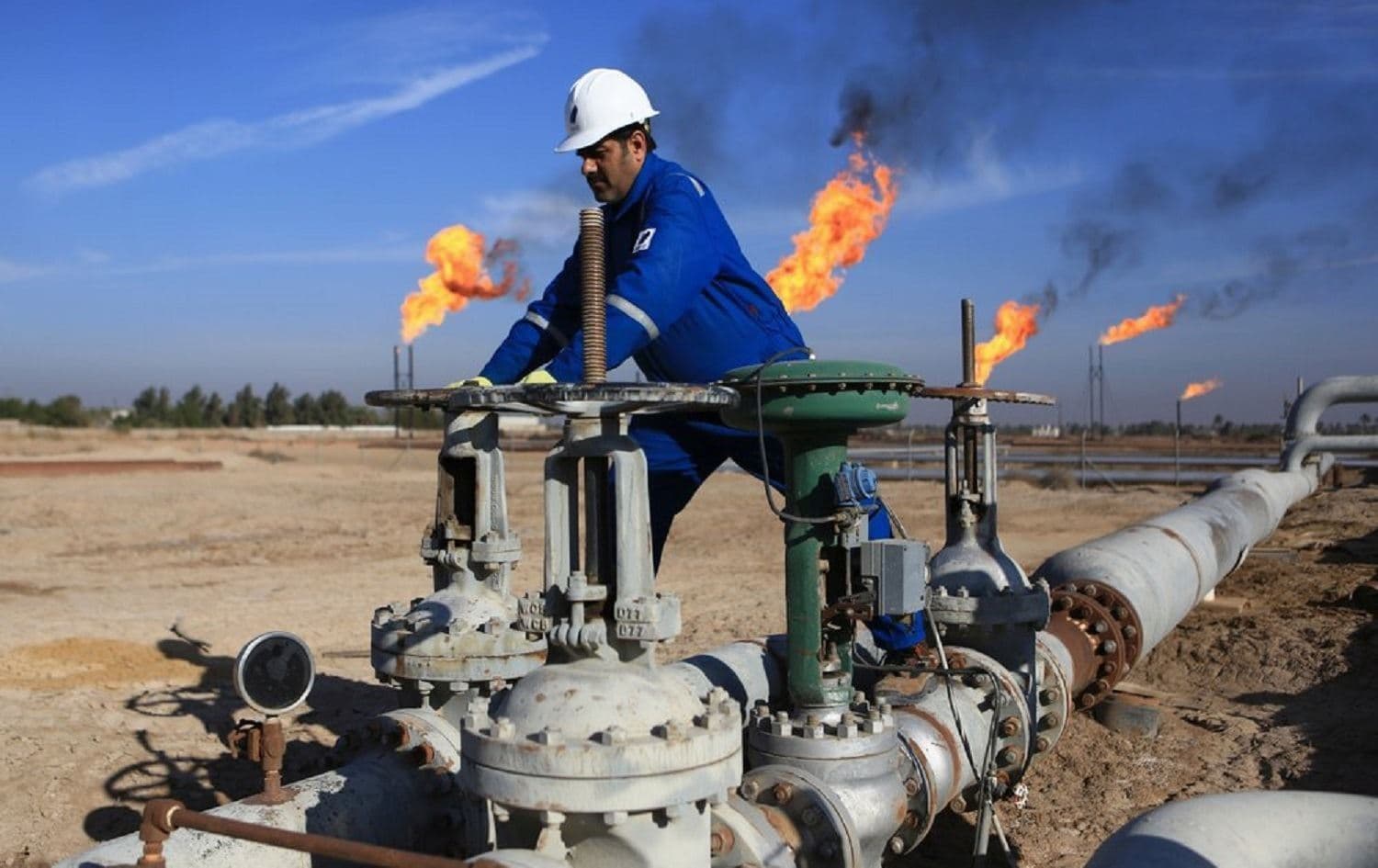 A worker operates valves in Nihran Bin Omar field north of Basra, Iraq, on January 12, 2017. File photo: Nabil al-Jurani/AP