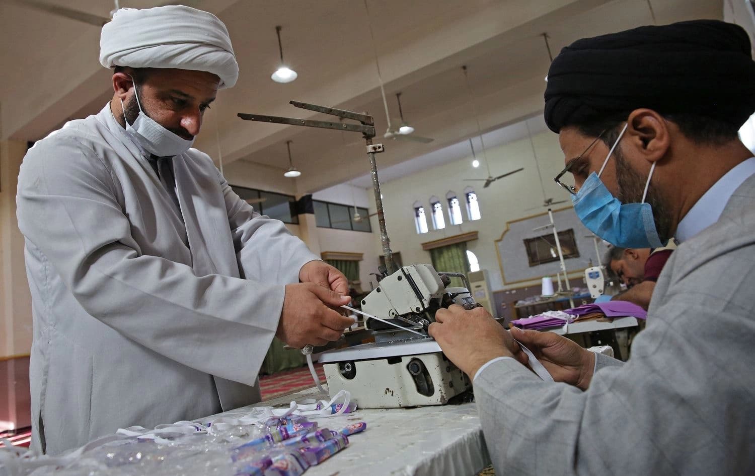 Iraqi Shiite clerics work in the al-Sadiqeen mosque in Baghdad turned into a mask production centre on April 27, 2020. Photo: Ahmad al-Rubaye/ AFP