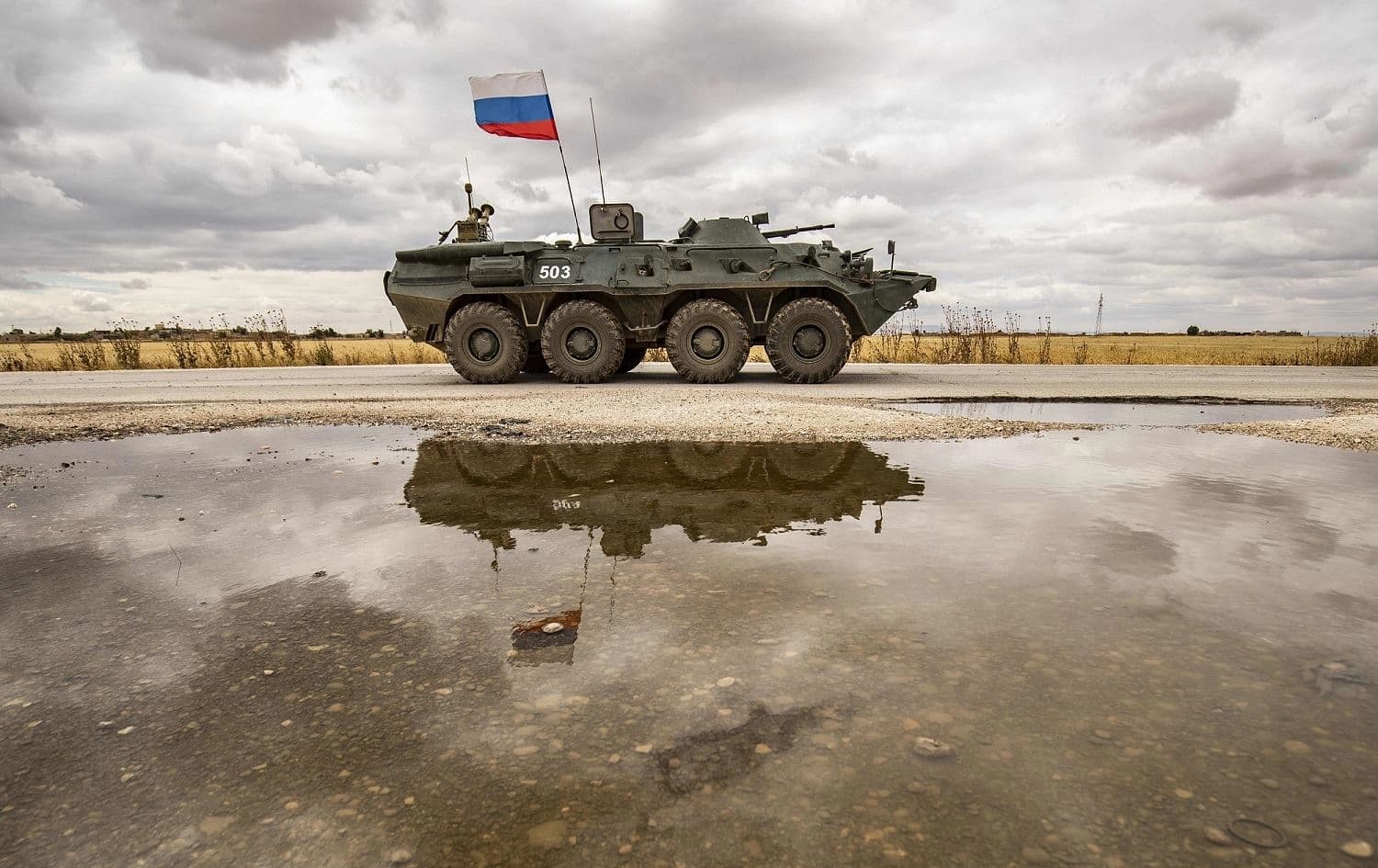 A Russian military vehicle drives along the M4 highway near the town of Tel Tamir, May 25, 2020. Photo: Delil Souleiman / AFP