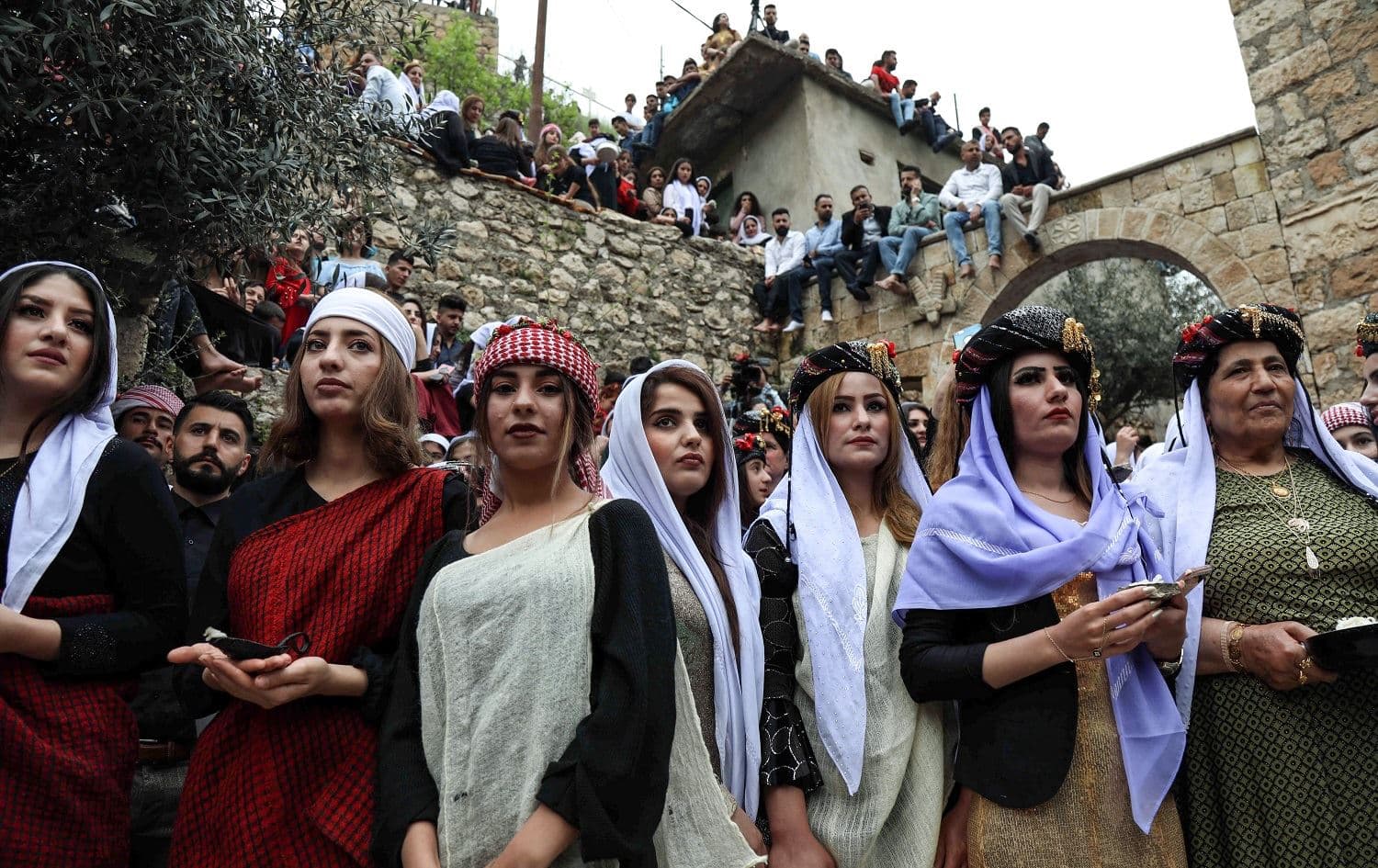 Yezidi women gather outside the ancient Temple of Lalish during a ceremony marking the Yezidi New Year. Photo: AFP / Safin Hamed