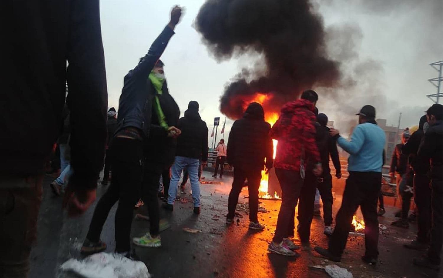 Iranian protesters gather around a fire during a demonstration in Tehran. Photo: AFP