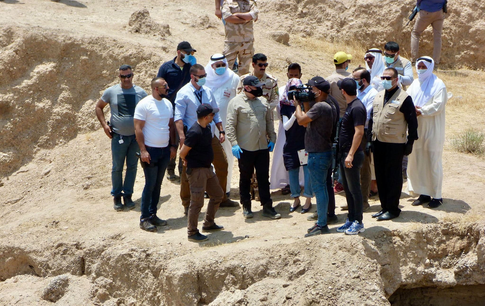 Special Adviser Karim Khan QC and UNITAD team members with Iraqi counterparts at a mass grave site north of Ramadi. Photo: UNITAD on social media
