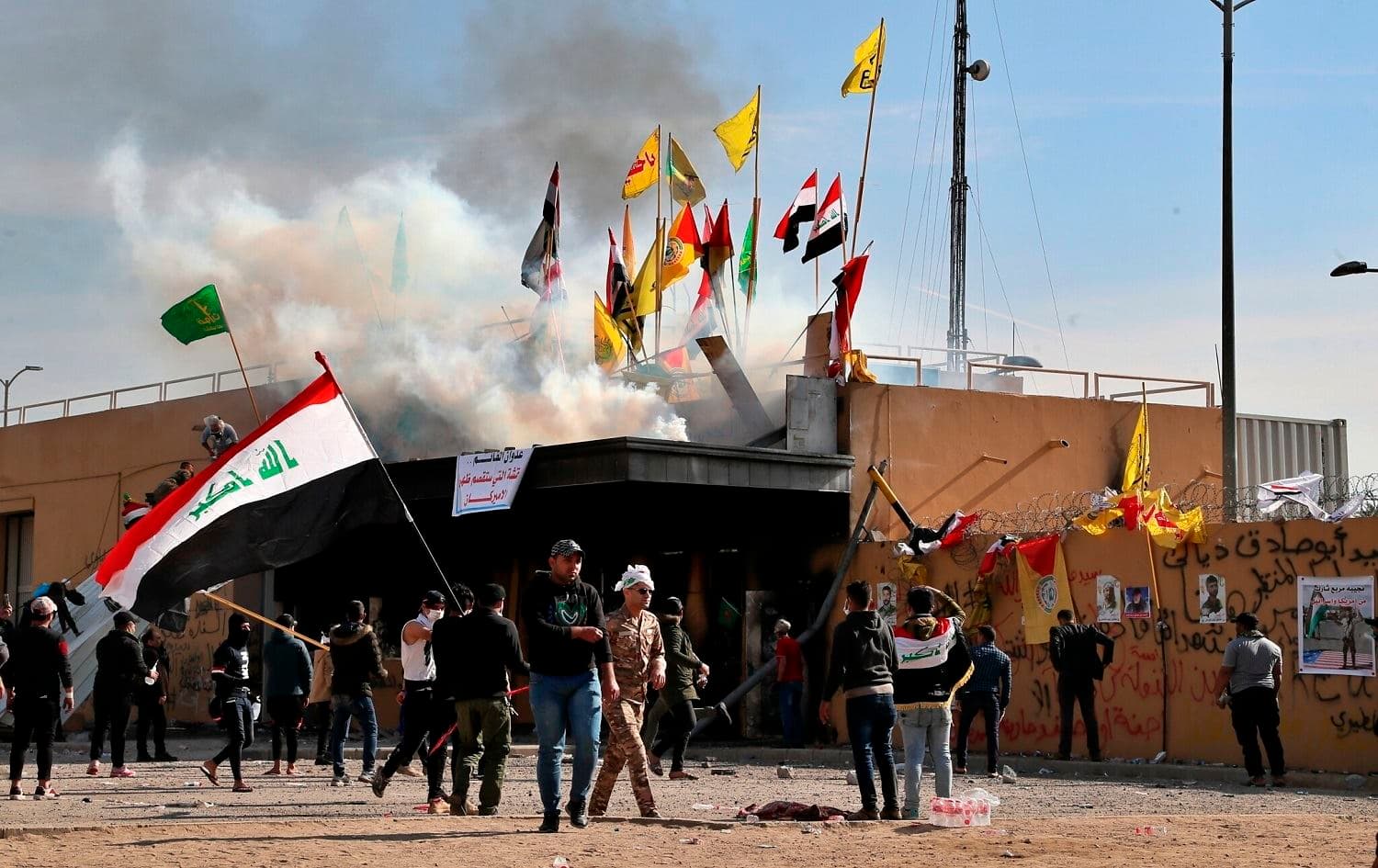 Pro-Iranian militiamen and their supporters set a fire in front of the US embassy in Baghdad on January 1, 2020. Photo: Khalid Mohammed/AP