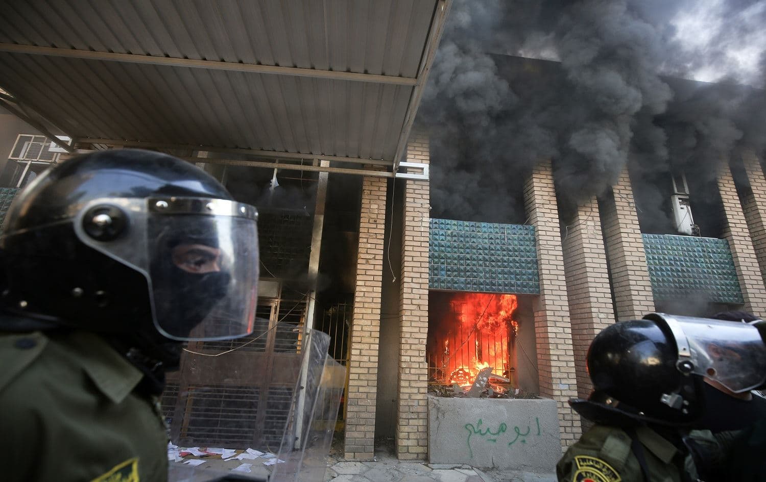 Iraqi security forces intervene as demonstrators burn down the KDP headquarters in Baghdad on October 17, 2020. Photo: Ahmad al Rubaye/AFP