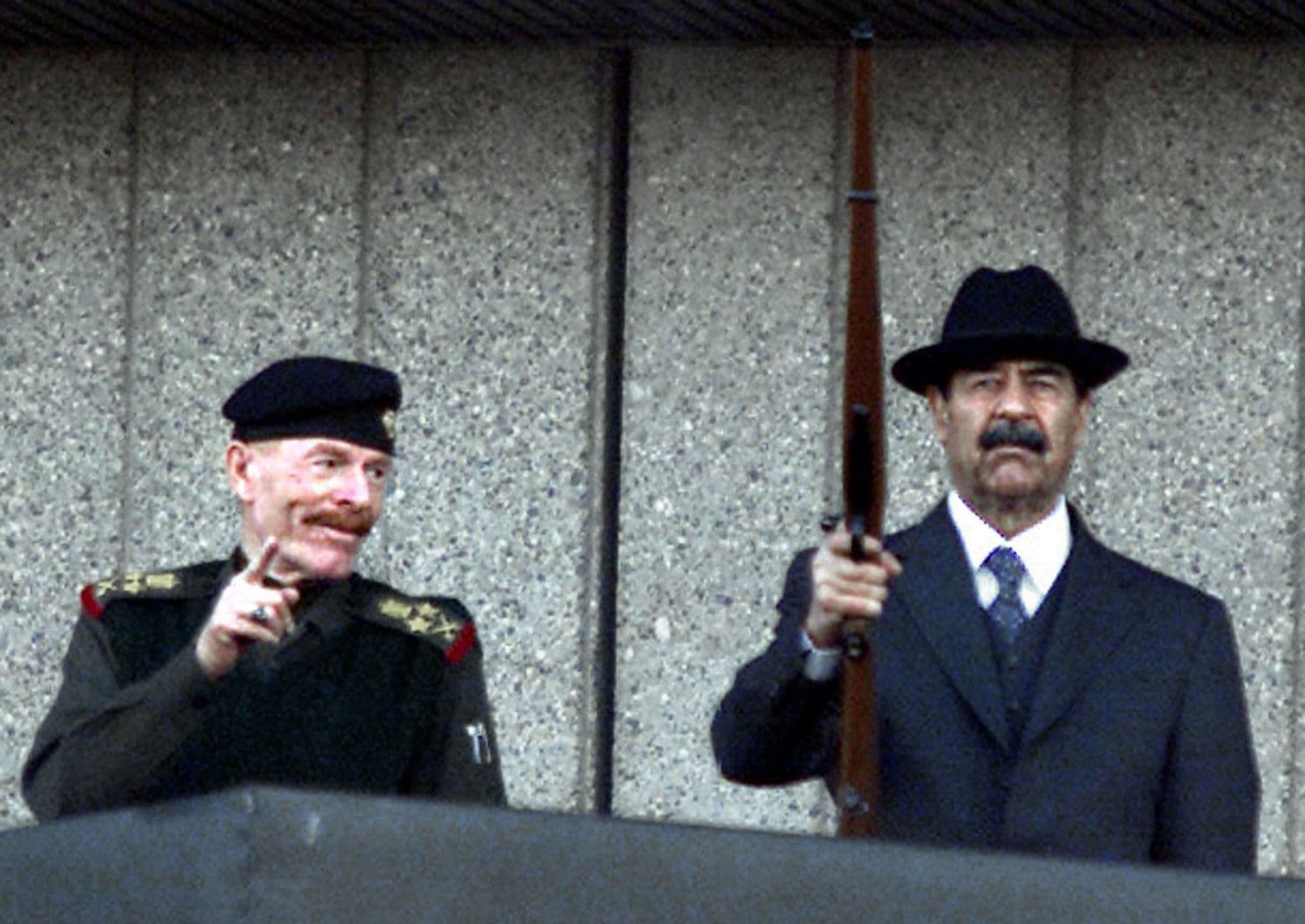 In this file photo taken on December 31, 2000, Iraqi President Saddam Hussein (R) and the vice president of the ruling Revolutionary Command Council, Izzat Ibrahim al-Duri, attend a military parade at Baghdad's Victory Square. Photo: Karim Sahib / AFP