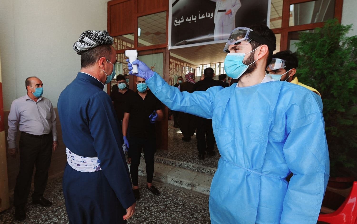 A man has his temperature checked as part of coronavirus precautions before entering a memorial for Yezidi spiritual leader Baba Sheikh Khurto Hajji Ismail who died on October 1, 2020. File photo: Bilind T. Abdullah/Rudaw