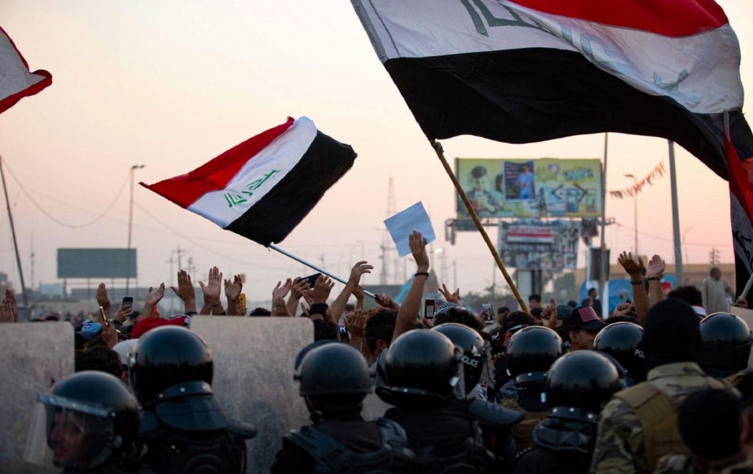  Iraqi anti-government protesters confront security forces in the southern city of Basra, on 31 October 2020 (AFP)