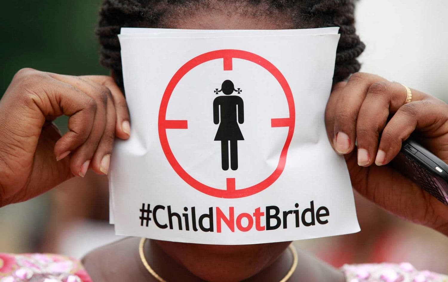 A woman holds a poster condemning child marriage. File photo: AP
