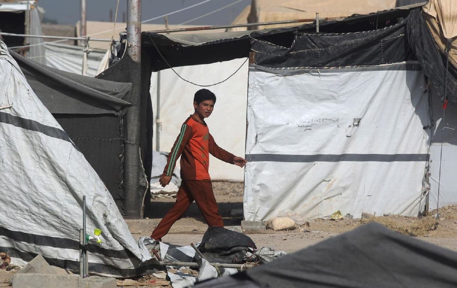 A boy walks through the Habbaniyah displaced persons camp in Anbar province. File photo: AFP