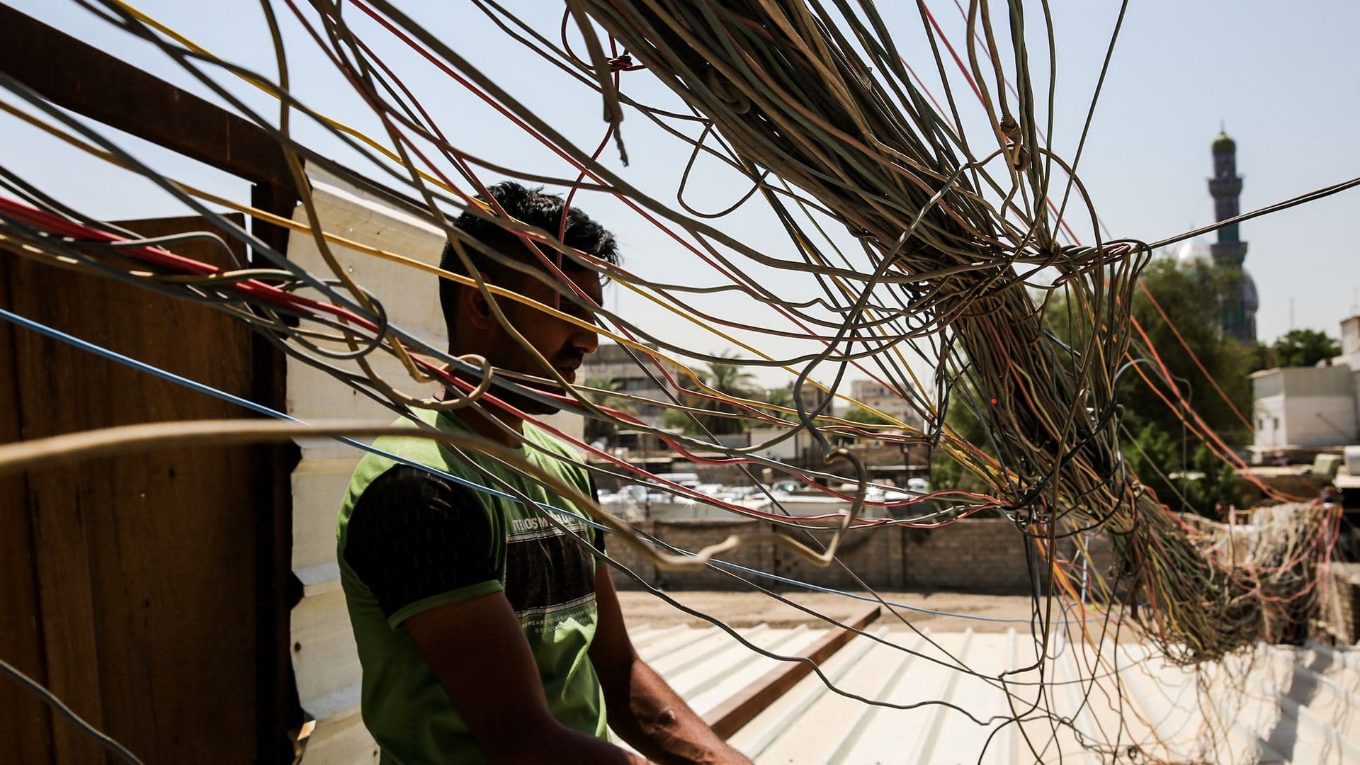 A man checks electrical wires in Baghdad. File photo: Sabah Arar/AFP