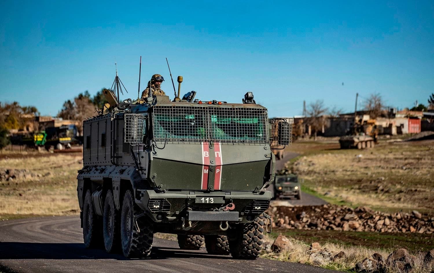 A soldier sits atop a Russian military vehicle taking part in a joint Russian-Turkish patrol near the town of al-Jawadiyah, Hasaka province, northeast Syria on December 24, 2020. File photo: Delil Souleiman/AFP