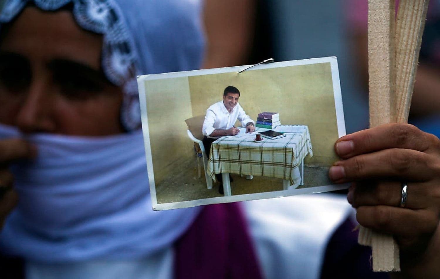 A supporter of the HDP holds a picture of Selahattin Demirtas at a rally. File photo: Emrah Gurel / AP 