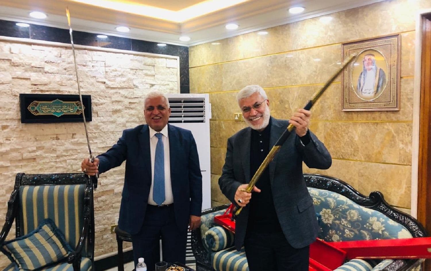 Senior Popular Mobilization Forces (PMF) leader Falih al-Fayyadh (left) is pictured in this undated photograph with now deceased PMF commander Abu Mahdi al-Muhandis (right) released by PMF media. Photo: PMF media/Twitter