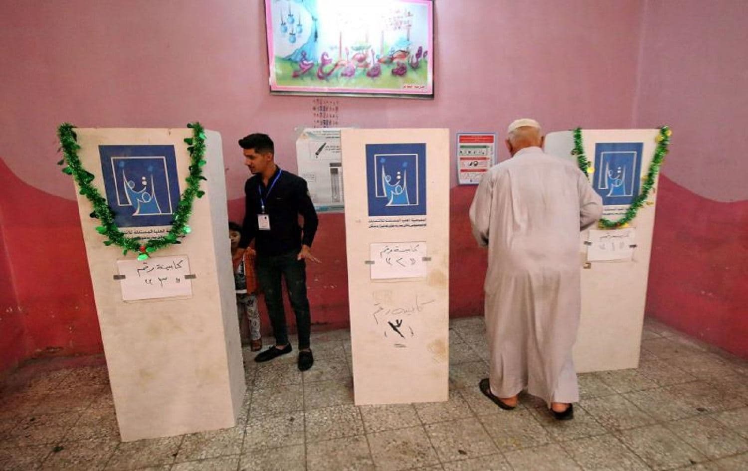 An Iraqi man enters a voting booth at a polling station in the southern city of Basra in 2018. File photo: AFP