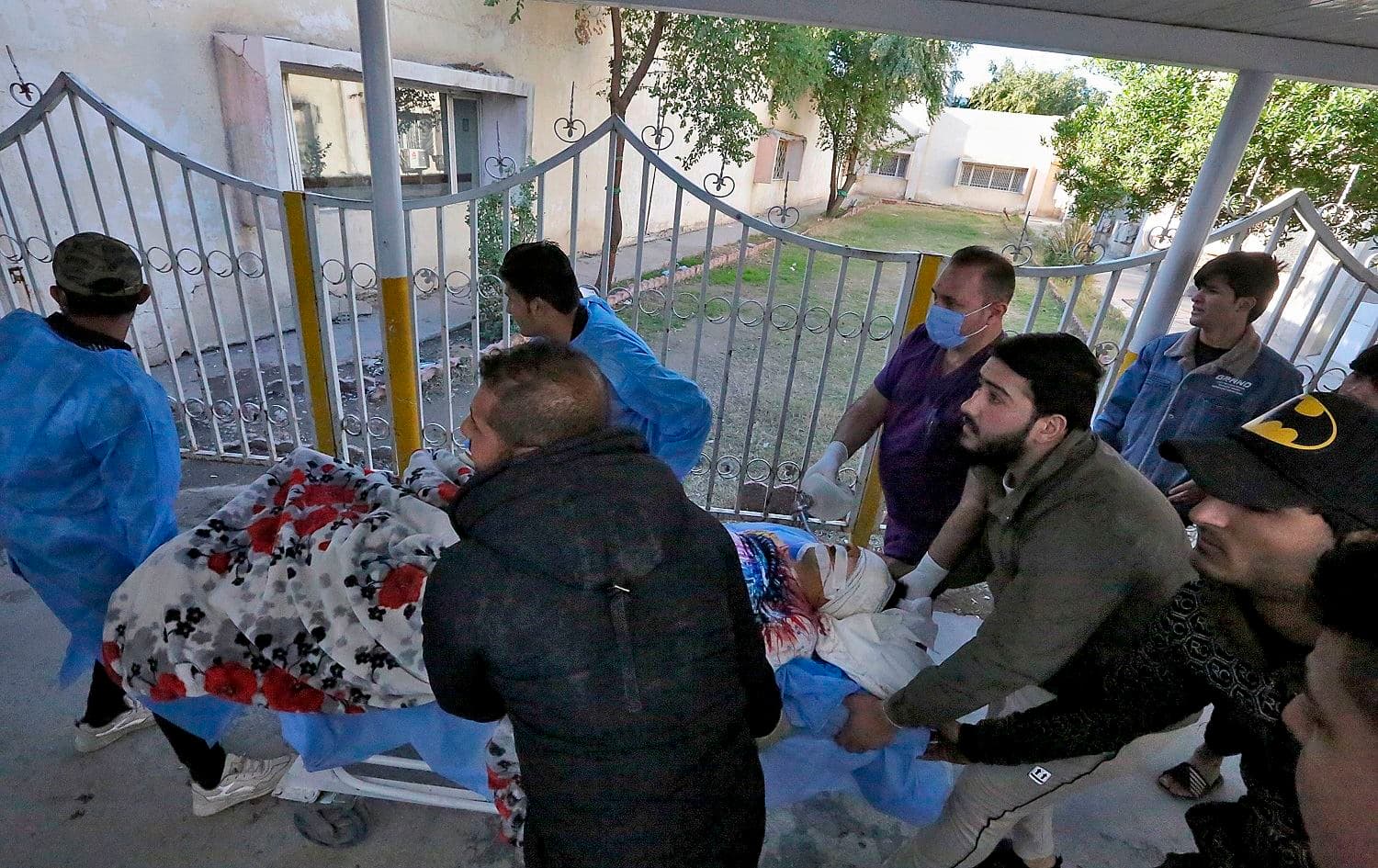 An injured man is rushed to a hospital following a twin suicide bombing on a bustling commercial street in the heart of the Iraqi capital Baghdad, on January 21, 2021. Photo: Sabah Arar/AFP