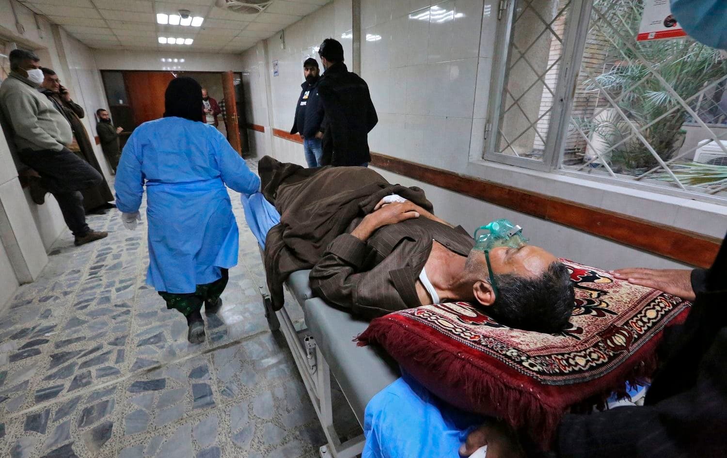 An injured man awaits treatment at a hospital following a twin suicide bombing on a bustling commercial street in the heart of the Iraqi capital Baghdad, on January 21, 2021. Photo: Sabah Arar/AFP
