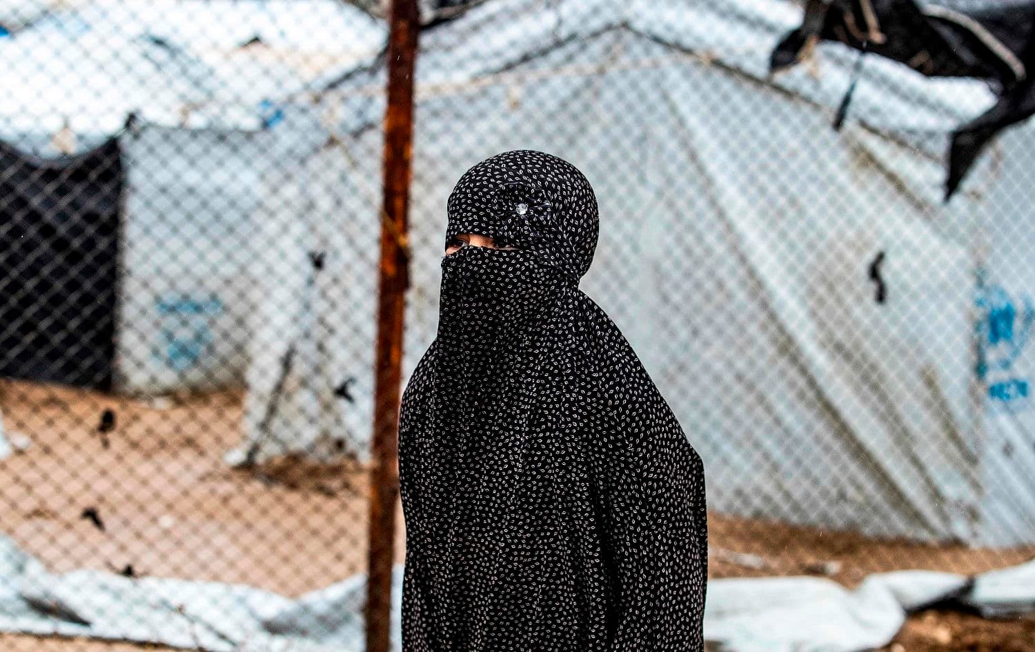 A veiled woman looks on during the release of persons suspected of being related to Islamic State (IS)  fighters from the Kurdish-run al-Hol camp on January 19, 2021. Photo: Delil Souleiman/AFP