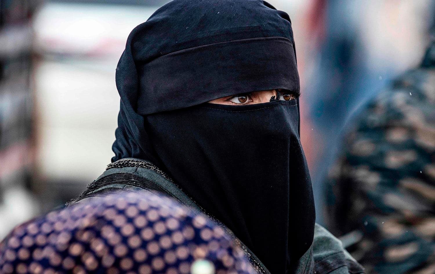 A person suspected of being related to ISIS fighters looks on before being released from al-Hol camp on January 19, 2021. Photo: Delil Souleiman/AFP