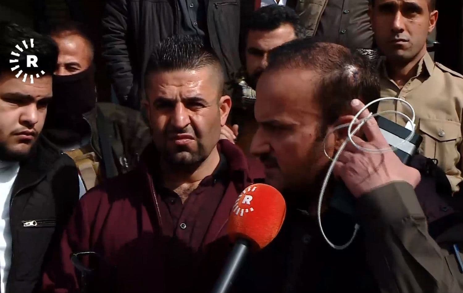 Police officer points to his injured head while speaking to press on Feburary 4, 2021. Photo: Rudaw