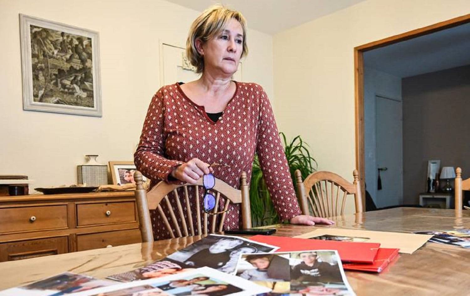 Pascale Descamps with photos of her daughter and grandchildren at her home in Boulogne-sur-Mer, France on November 25, 2020. Photo: AFP