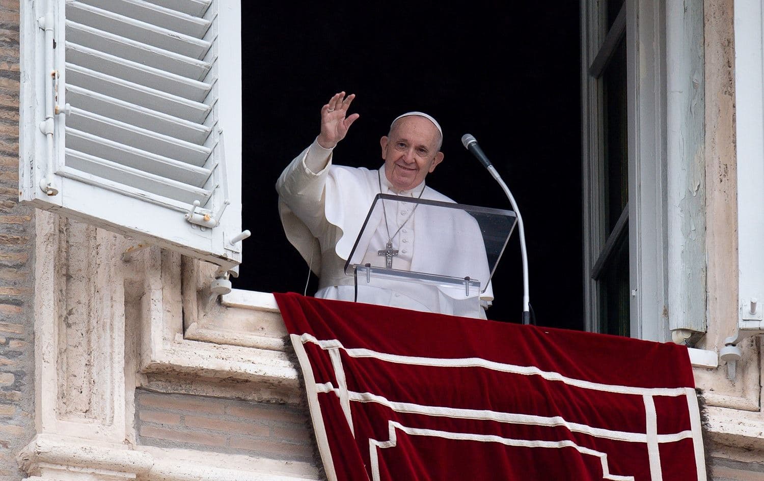 Pope Francis waves from the window of the apostolic palace during the weekly Angelus prayer in the Vatican on February 7, 2021. Photo: AFP/Vatican Media/handout