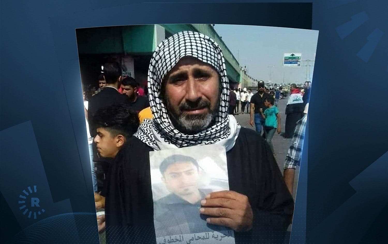 Jaseb Hattab holding a picture of his missing son Ali. Photo: social media 