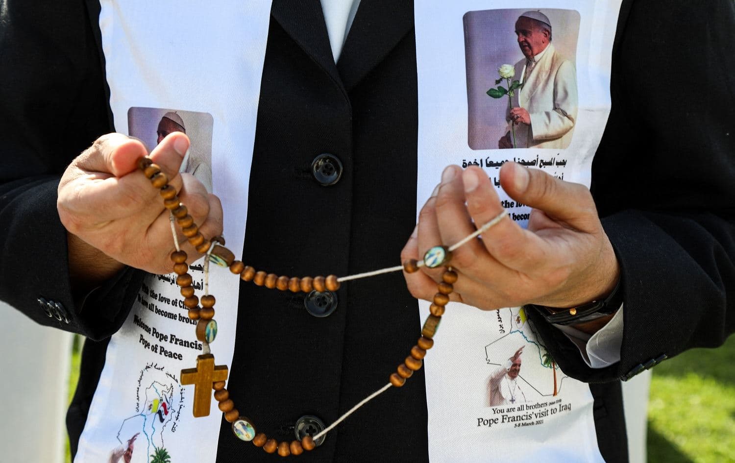 A nun holds a rosary while praying as she awaits the arrival of Pope Francis at Erbil's Franso Hariri Stadium on March 7, 2021. Photo: Safin Hamed/AFP
