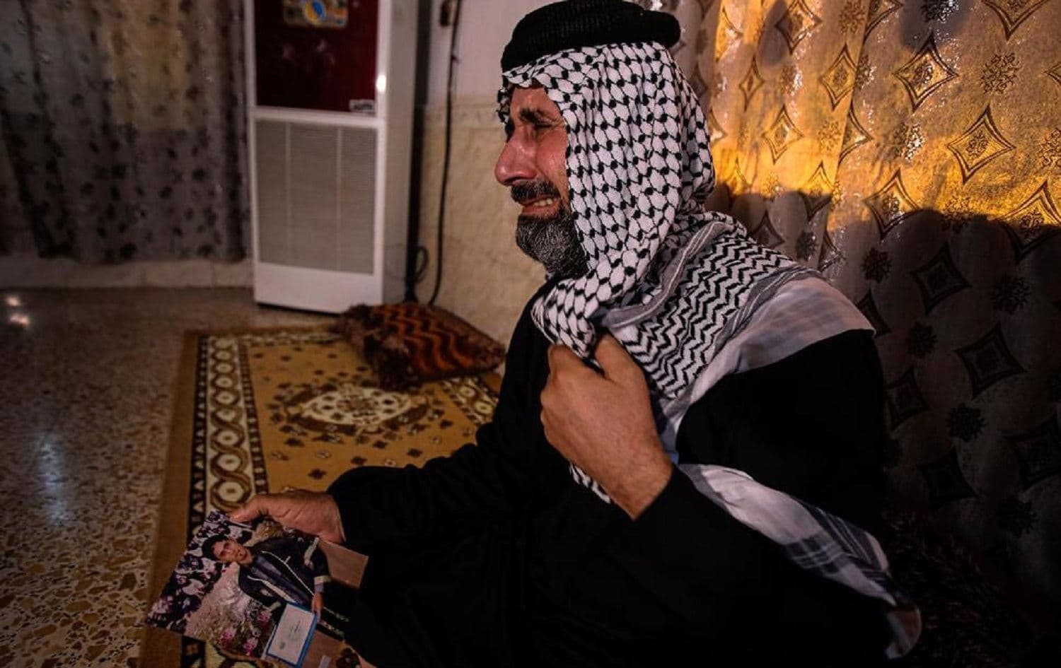 Jaseb Hattab, father of the kidnapped protester Ali Jaseb, cries as he holds his son's picture in his home in the town of Amarah, Iraq on July 29, 2020. File photo: Nabil al-Jurani/AP