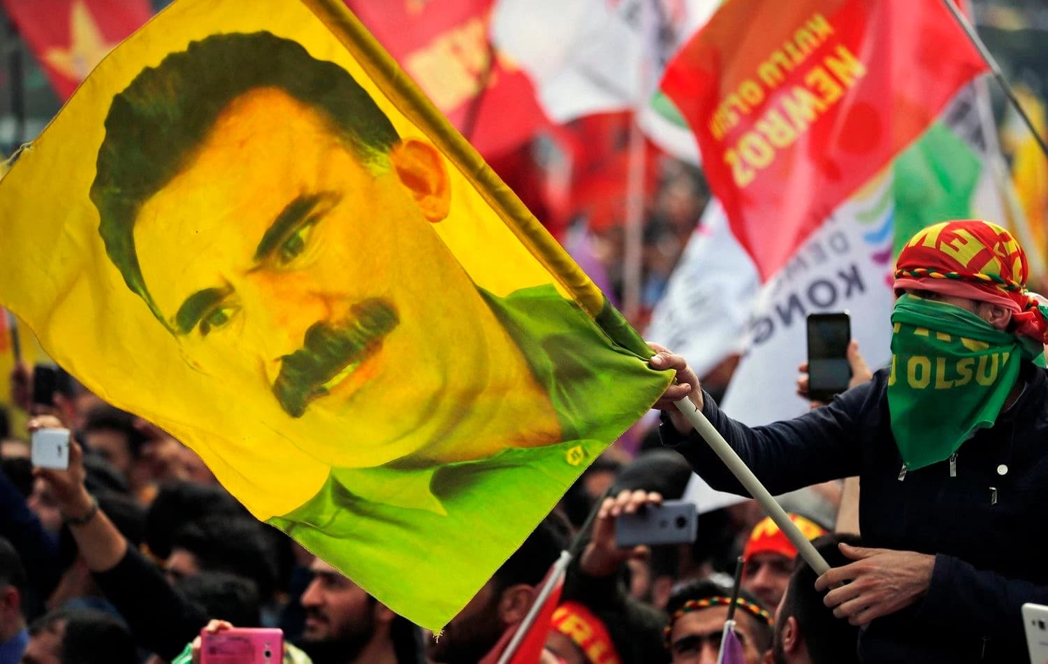 A youth holds a flag with the image of Abdullah Ocalan in Istanbul, Turkey on March 21, 2018. Photo: AP