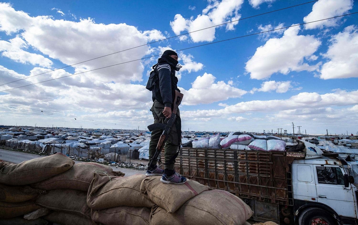 A security force member looks over al-Hol camp in Hasaka province, northeast Syria on March 18, 2021. Photo: Delil Souleiman/AFP