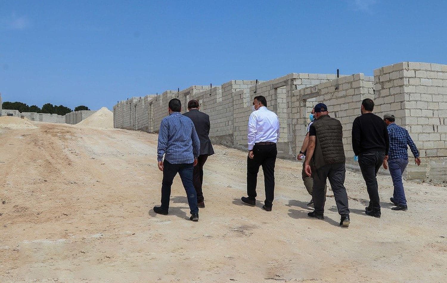 Mohammed Sheikh Rasheed, deputy head of the council and Ahmed Haji Hussein head of Afrin Health Directorate, and unidentiifed people visit the site of the village on April 17, 2021. Photo: Afrin Local Council