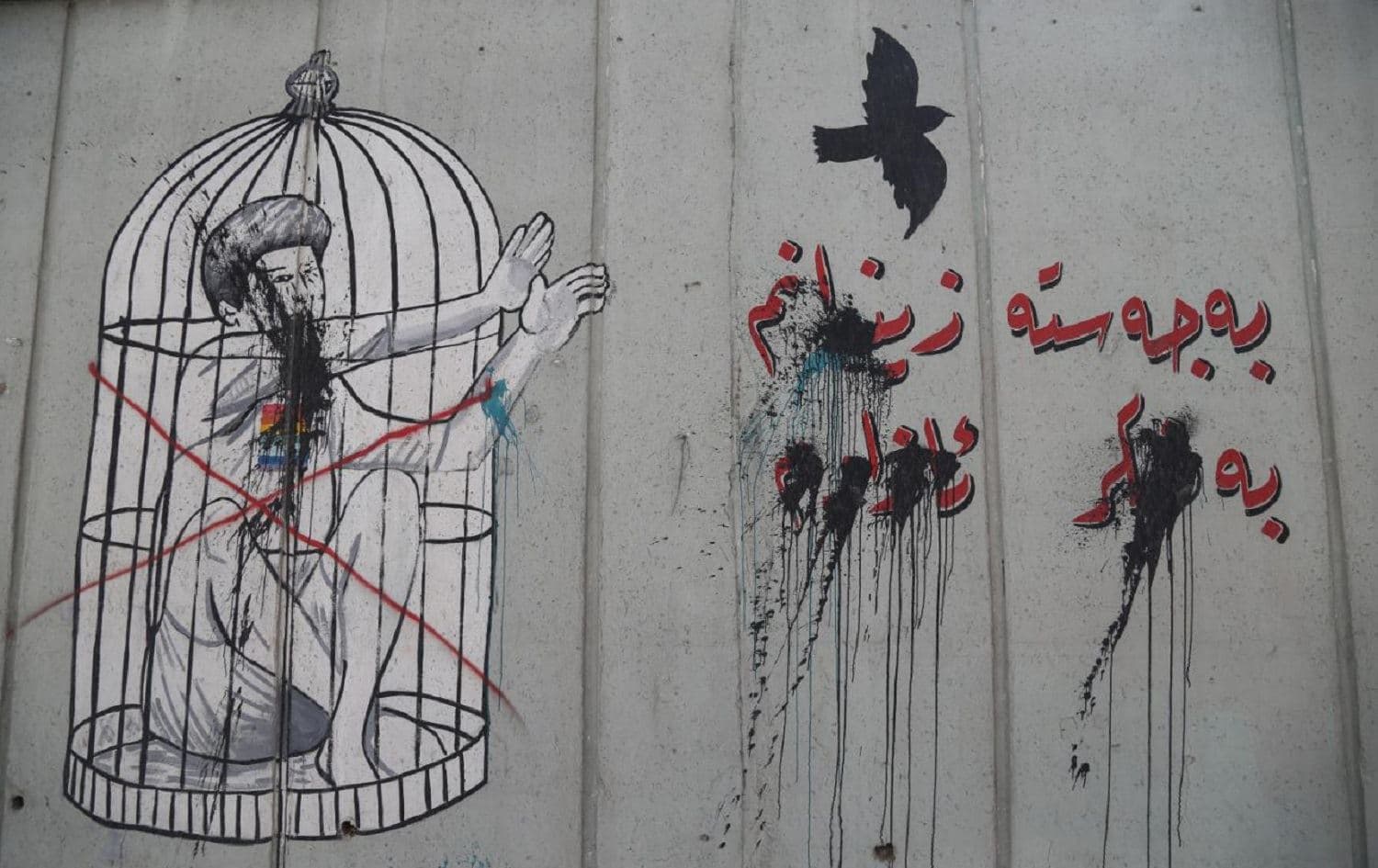 A vandalized mural in support of the LGBT+ community in Sulaimani says "Physically I am imprisoned; Mentally I am free." Photo: Hama Sur