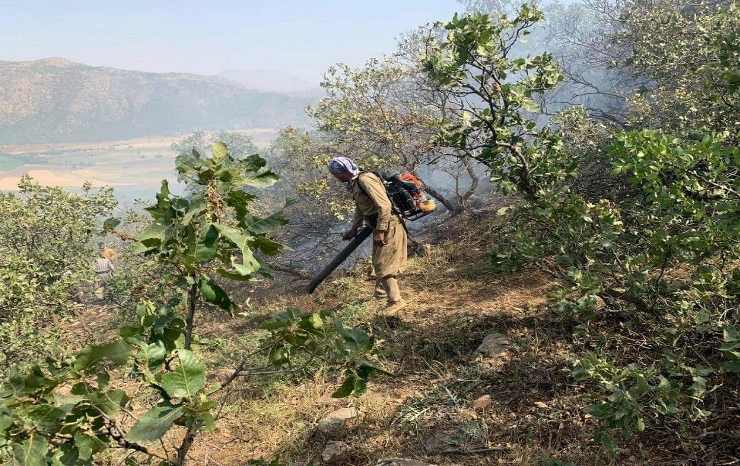 A member of the Green Mountains Committee puts out a fire. Photo: Green Mountains Committee