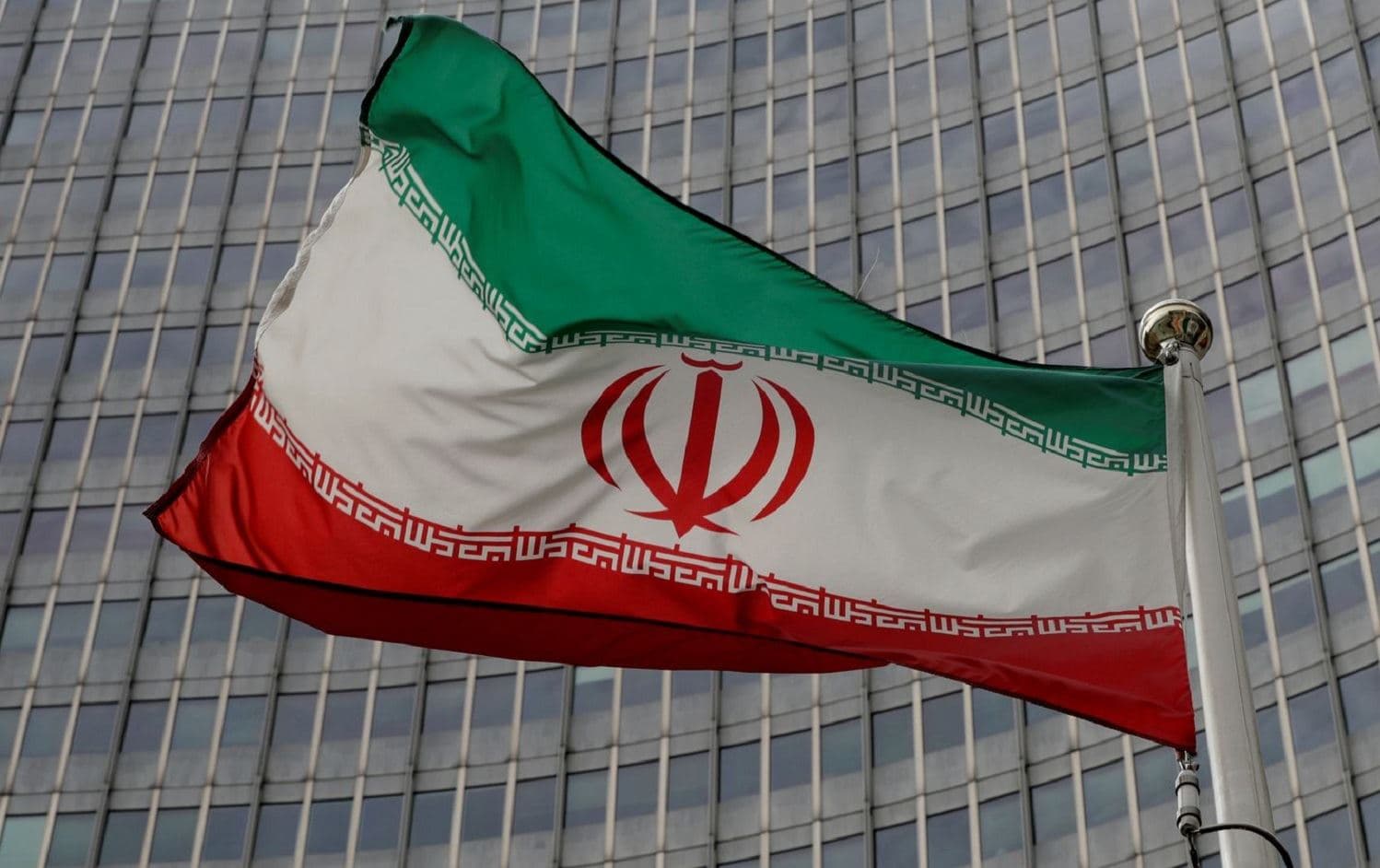 An Iranian flag flutters in front of the International Atomic Energy Agency (IAEA) headquarters in Vienna