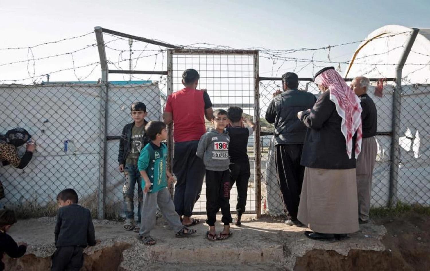 Families wait for food distribution at the Hasansham camp for internally displaced persons, northern Iraq, Dec. 10, 2020. File photo: AFP via Getty Images/Florent Vergnes