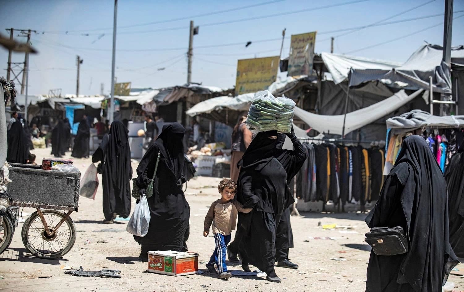 People walk about at the Kurdish-run al-Hol camp, which holds relatives of suspected Islamic State (ISIS) members in northeastern Syria, on June 23, 2021. Photo: AFP/ Delil Souleiman