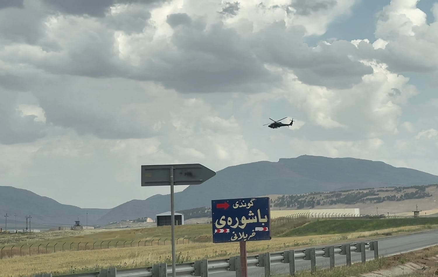 A helicopter flies over the Bashur airbase near the town of Harir, in Erbil province, in May 2021. Photo: Fazel Harwamy/Rudaw