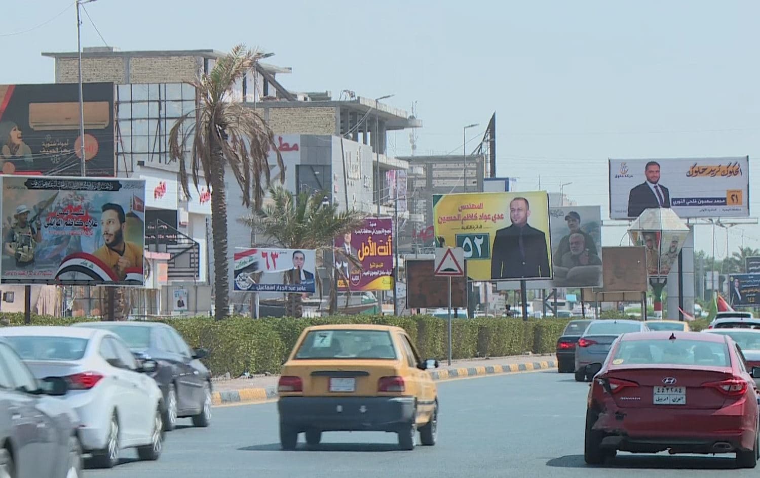 Election campaign posters line a busy street in Basra on September 30, 2021. Photo: Rudaw