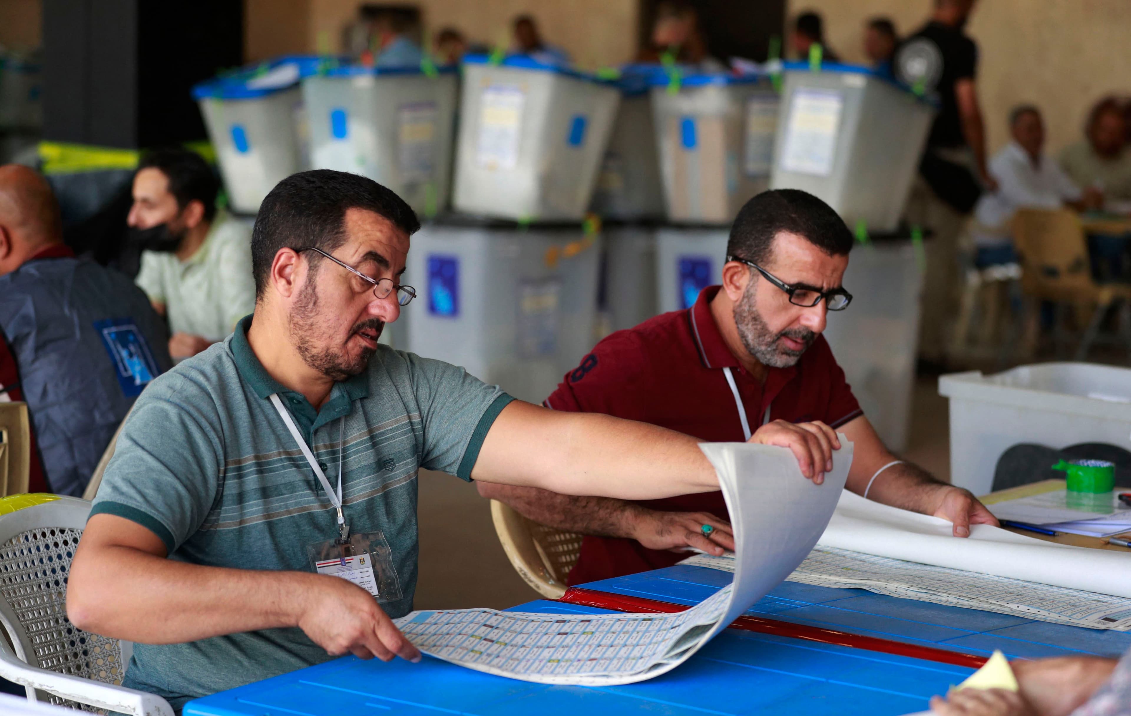 Employees of Iraq’s Independent High Electoral Commission conduct a manual recount of votes following the parliamentary elections in Baghdad’s Green Zone area on October 27, 2021. Photo: Ahmad al-Rubaye/AFP