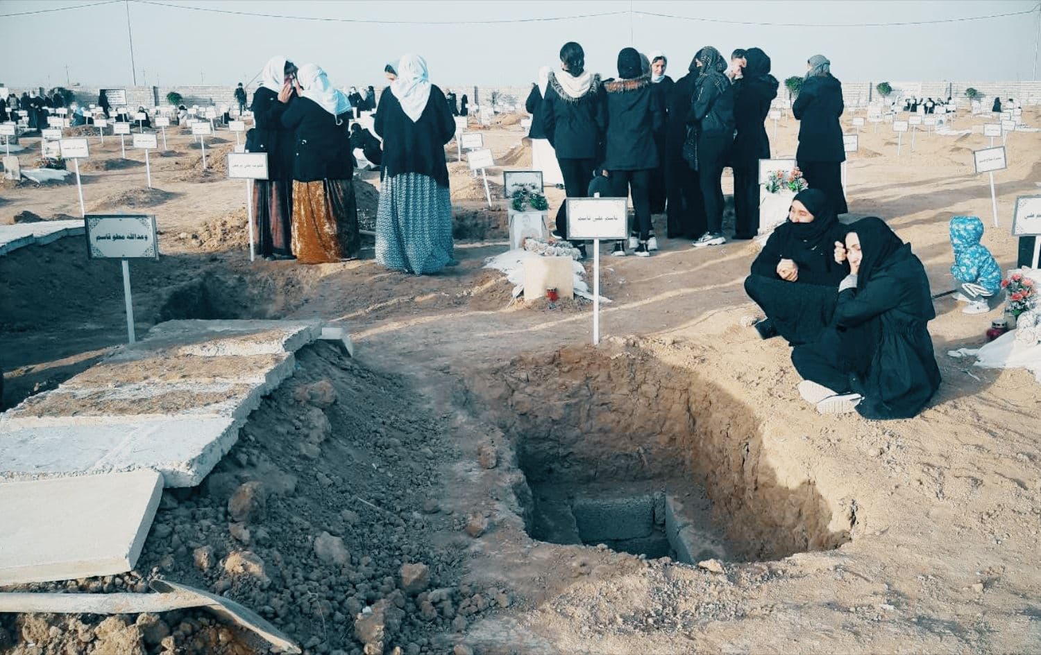 Yazidis at the graves of members of their community killed by Islamic State, taken on December 9, 2021. Photo: Rudaw