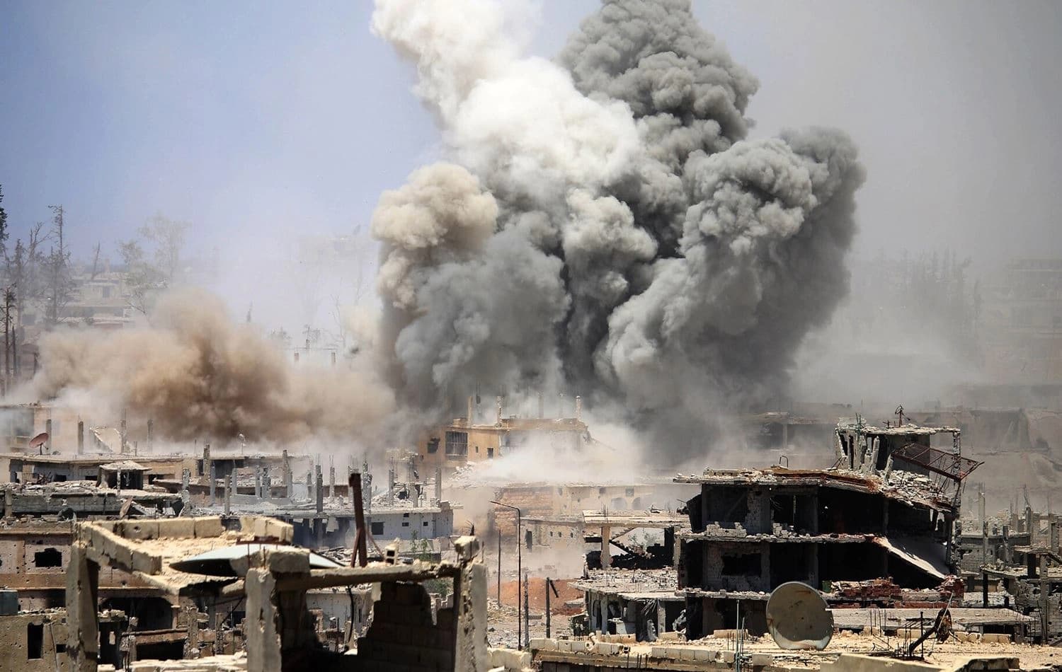 Smoke rises from buildings following a reported airstrike on a rebel-held area in the southern Syrian city of Daraa on May 22, 2017. Photo: AFP